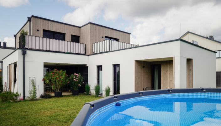 Modern white house with swimming pool and outdoor terrace.